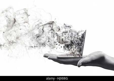 Human hand holding burning laptop on palm Stock Photo