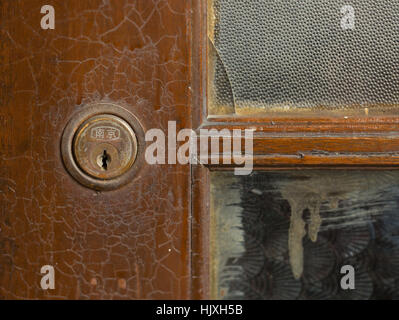 Door window pane and door lock with brass fittings in 1930s building, Nanjing, China Stock Photo
