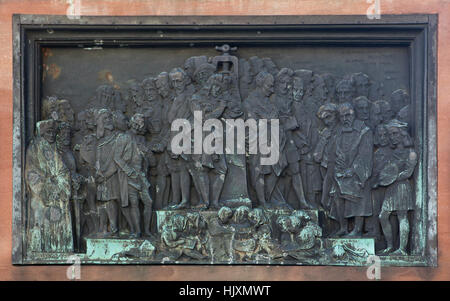 Bronze relief devoted to the benefits of book printing for Europe on the monument to Johannes Gutenberg (1840) by French sculptor David d'Angers in Strasbourg, France. Erasmus, Durer, Voltaire, Descartes next to the printing press, Montesquieu, Leibniz, Alessandro Volta, Galilei and Raphael are depicted (from left to right) in the foreground. Torquato Tasso, Cervantes, Poussin, John Milton, Mozart, Moliere, Pierre Corneille, Shakespeare, Jean-Jacques Rousseau, Lessing, Immanuel Kant, Copernicus, Goethe, Friedrich Schiller, Hegel, Isaac Newton and Spinoza appear among the other in background Stock Photo