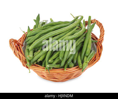 Green beans in wicker basket isolated on white background Stock Photo