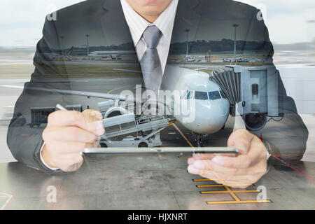 Double exposure of business man working with tablet and airport on motion background as Communication and Transportation concept. Stock Photo