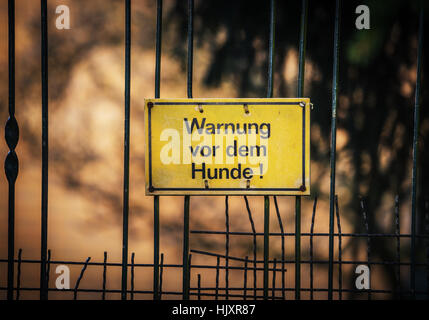 German warning sign hanging on the fence Stock Photo