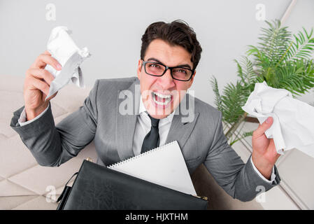 Angry businessman with crumbled paper Stock Photo