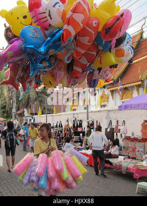 Balloon vendor walking street sunday afternoon market, Chiang Mai, Thailand Stock Photo