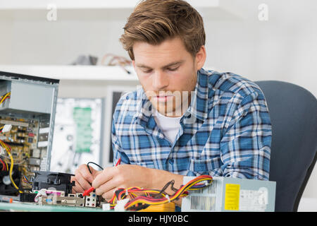young man fixing computer Stock Photo