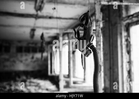 Infected radiation gas mask in an abandoned middle school in Chernobyl nuclear power plant zone of alienation Stock Photo