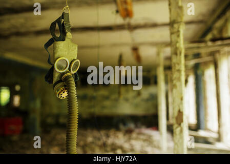 Infected radiation gas mask in an abandoned middle school in Chernobyl nuclear power plant zone of alienation Stock Photo