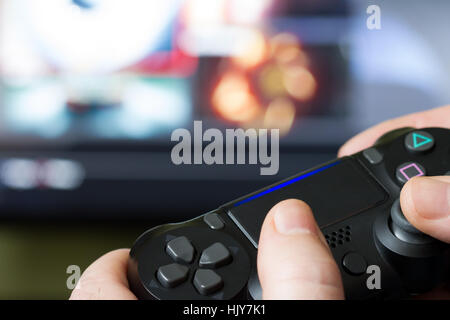 Video game controller from the console against the monitor screen Stock Photo
