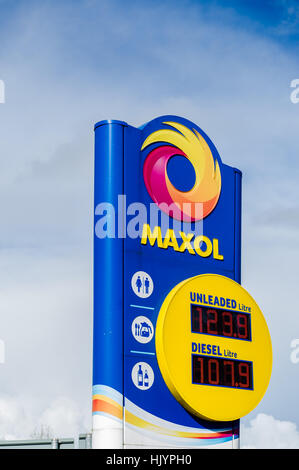 A Maxol petrol station sign in Ireland showing petrol and diesel prices and station facilities on a clear day with copy space. Stock Photo