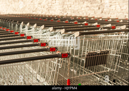 Supermarket shopping trollies lined up outside a supermarket Stock Photo