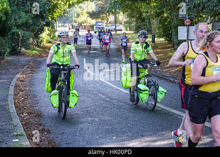 A pair of St John Ambulance paramedics support the Chester Marathon on their bicycles Stock Photo