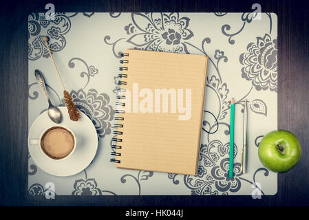 Notepad, cup of coffee, smartphone and digatal capera on the desktop. Journey planning concept Stock Photo