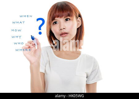 Asian woman writing wh- questions on virtual board with question mark Stock Photo