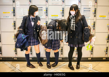 Students smiling, lockers room, at Shinjuku Railway station, Tokyo, Japan. Stock Photo