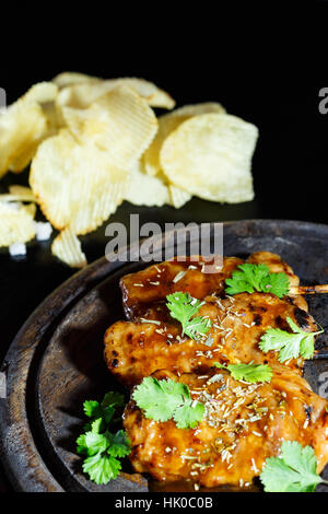 Food steak ready for serving on wood plate and black background, fresh steak from pork and beef, seasoning by vegetable and spices. Stock Photo