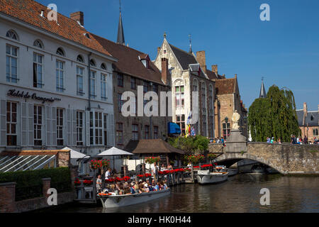 Tourists in boats travel on the Den Dijver canal in summer, Bruges, West Flanders, Belgium Stock Photo