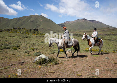 Gaucho guide and tourist on horse at Estancia Alta Vista, El Calafate, Parque Nacional Los Glaciares, Patagonia, Argentina