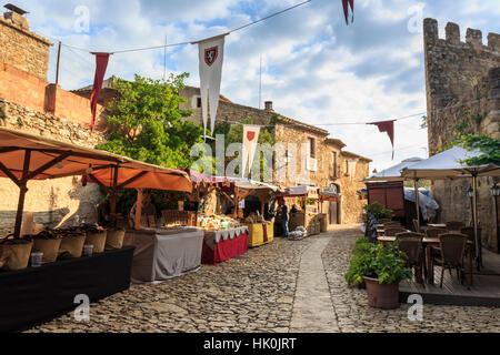 Gorgeous medieval village, market on cobblestone street with flags, Peratallada, Baix Emporda, Girona, Catalonia, Spain Stock Photo