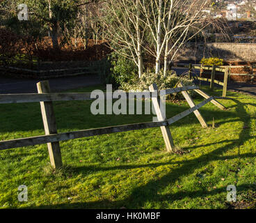 Wooden fence broken after being hit by a large van. Stock Photo