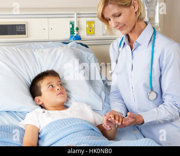 Doctor Visiting Child Patient On Ward Stock Photo 