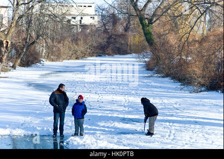 People playing on the frozen river Nit in Nove Zamkey Slovakia with temperature at minus 10c Stock Photo