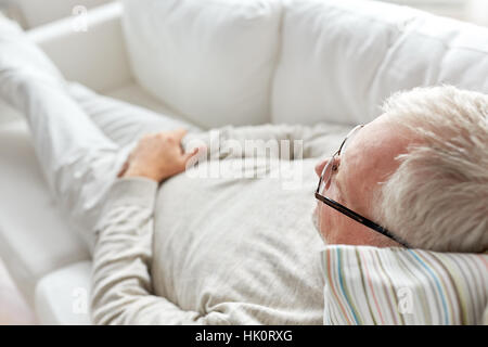 close up of senior man lying on sofa Stock Photo