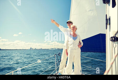 senior couple sailing on boat or yacht in sea Stock Photo