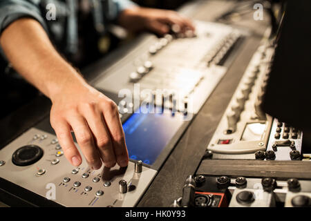 man using mixing console in music recording studio Stock Photo