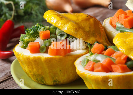 Round yellow squash stuffed with vegetables, close-up on the table horizontal Stock Photo