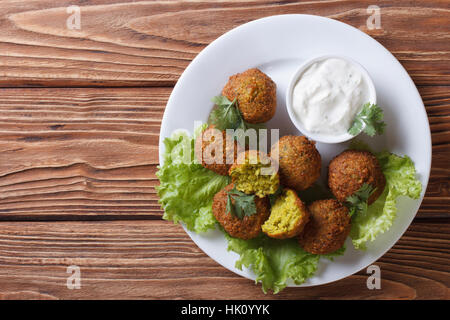 delicious falafel on lettuce with tzatziki sauce close-up view from above horizontal Stock Photo