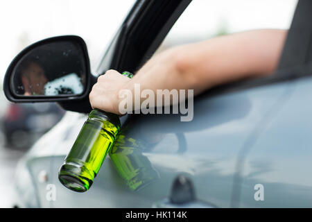 close up of man drinking alcohol while driving car Stock Photo