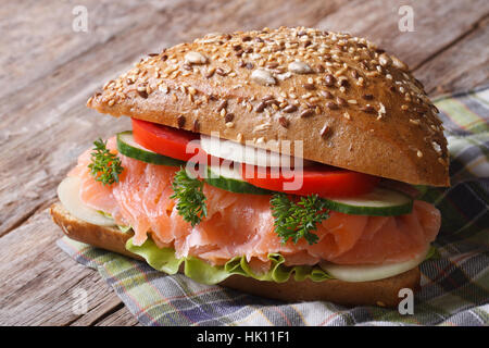 Delicious sandwich with salmon and vegetables close up on an old table horizontal Stock Photo