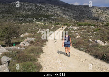 Mountain path in carboniferous limestone landscape, near Benimaurell, Vall de Laguar, Marina Alta, Alicante province, Spain Stock Photo