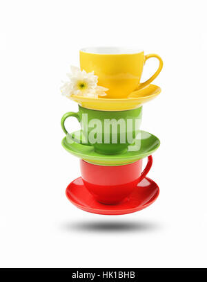 Three different colored cups facing each other on a white background Stock Photo