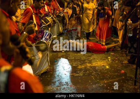 Kuala Lumpur, Malaysia. 4th February, 2017. Hindus devotees possessed by the god reacts in a state of trance as he's heading to the Batu caves in Kuala Lumpur, Malaysia on February 04, 2017. To mark this day, Hindus devotees pierce different part of their body with various metal skewers and carry pots of milk on their heads along couple of kilometers to celebrate the honor of Lord Subramaniam (Lord Murugan) in the Batu Caves, one of the most popular shrine outside India and the focal point to celebrate the Thaipusam Festival in Malaysia. Credit: Chris JUNG/Alamy Live News Stock Photo