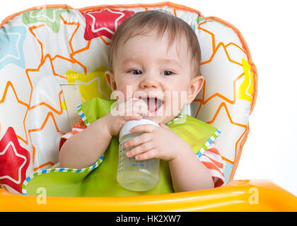 baby holding bottle and drinking water Stock Photo