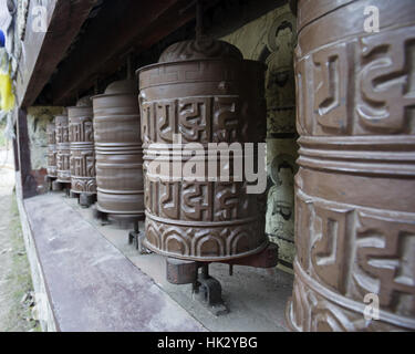 prayer wheels in Nepal with motion blur on one turning wheel Stock Photo