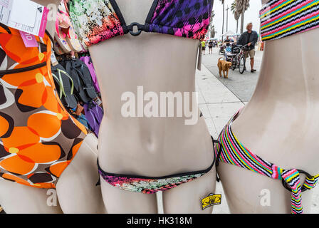 Three woman mannequins modeling brightly-colored bathing suits for sale at a shop in Venice Beach, California. Stock Photo
