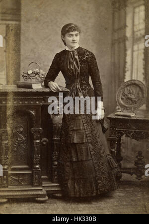 Antique c1890 cabinet card photograph, finely dressed young woman in Boston, Massachusetts, USA.