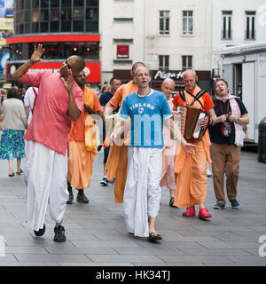 London, UK - July 17, 2016. Hare Krishna followers walk down London's Oxford Street in their orange robes Stock Photo