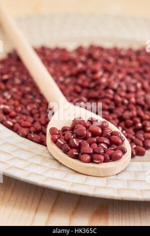 Raw uncooked adzuki red beans in wooden spoon Stock Photo