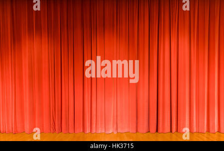 A curtain in light red color, covering a theater stage Stock Photo