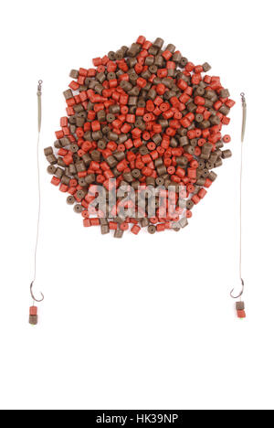 Fishing bait with hook and brown with red pre-drilled halibut pellets for carp fishing isolated on white Stock Photo