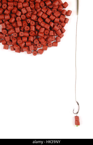 Fishing bait with hook and red pre-drilled halibut pellets for carp fishing isolated on white Stock Photo