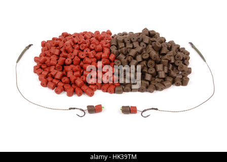 Fishing bait with hook and brown with red pre-drilled halibut pellets for carp fishing isolated on white background Stock Photo