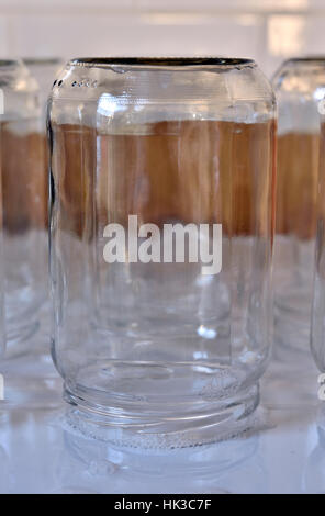 Empty glass jar upside down on draining board Stock Photo