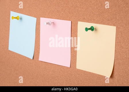 Close up of three  blank paper notes on cork board Stock Photo