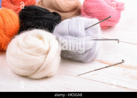 Close up of wool needle felting kit on wooden surface Stock Photo