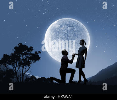Silhouettes of romantic couple under the moon light Stock Photo - Alamy