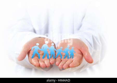 Close up of human hands with row of people figures Stock Photo